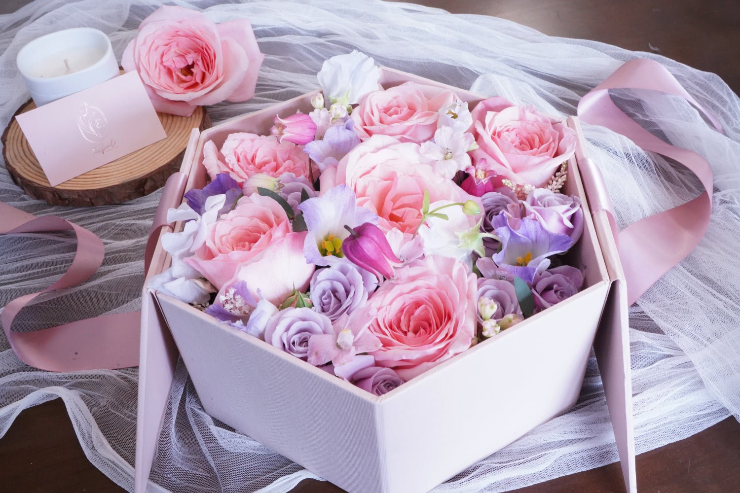 A assortment of floral arrangements, some in crafted baskets while others are elegantly presented in decorative boxes